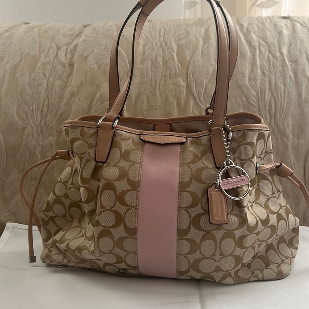 The brand is coach is light brown and pink new condition used only twice